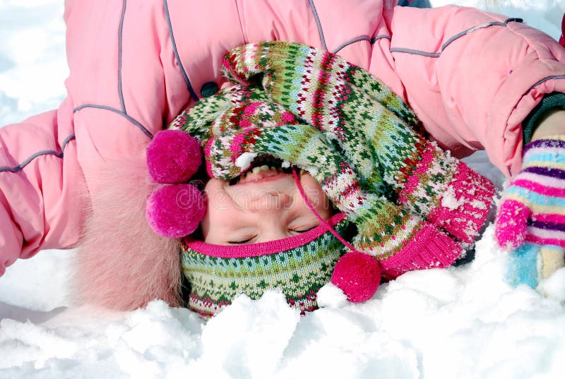 Happy little girl in winter clothing upside down royalty free stock photos Happy little girl in winter clothing upside down royalty free stock photos