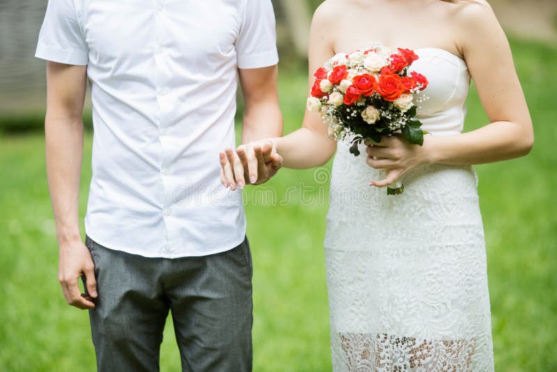 Happy married couple holding hands outdoor with flowers royalty free stock photos Happy married couple holding hands outdoor with flowers royalty free stock photos