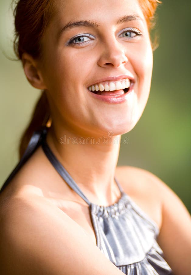 Happy lovely sweet smiling red-haired girl, outdoors