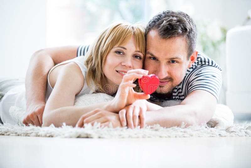 Happy loving couple, heart box in hand