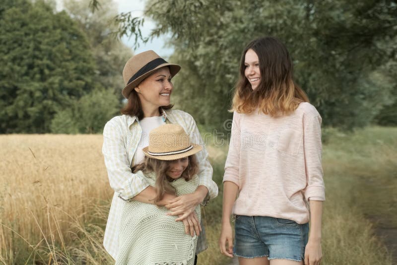 Happy loving family mother and children two daughters walking together stock photos Happy loving family mother and children two daughters walking together stock photos