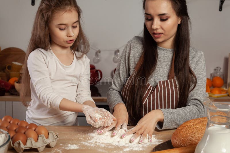 Mother And Her Daughter Are Baking A Bread And Having Fun At The
