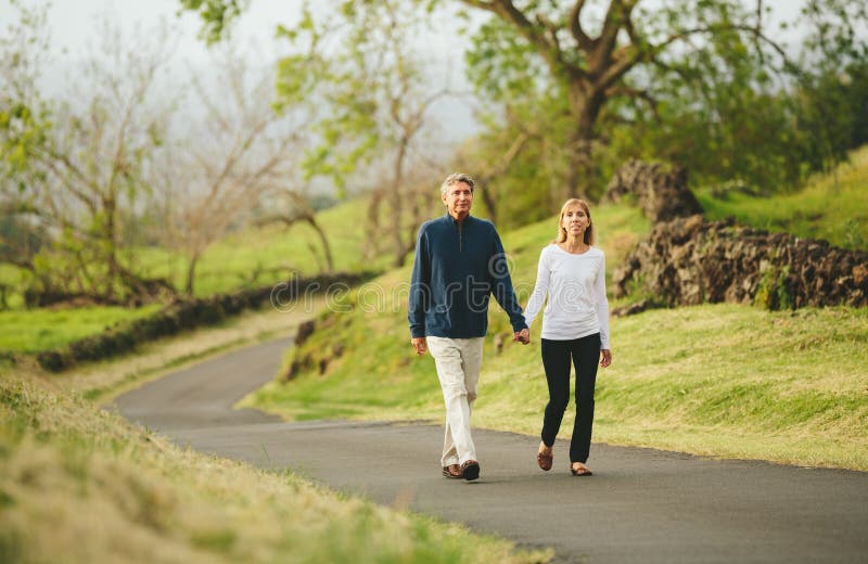 Happy loving middle aged couple walking