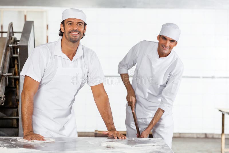 Happy Male Baker S in Uniform Cleaning Bakery Stock Photo Image of