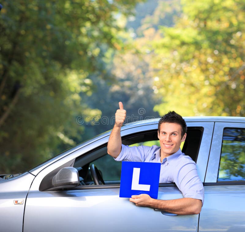 Happy male in car holding a L sign royalty free stock photos Happy male in car holding a L sign royalty free stock photos