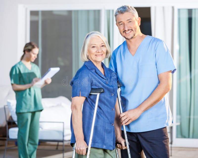 Happy Male Caretaker And Disabled Senior Woman