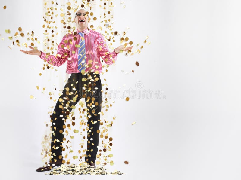 Happy Male Executive Under Shower Of Gold Coins