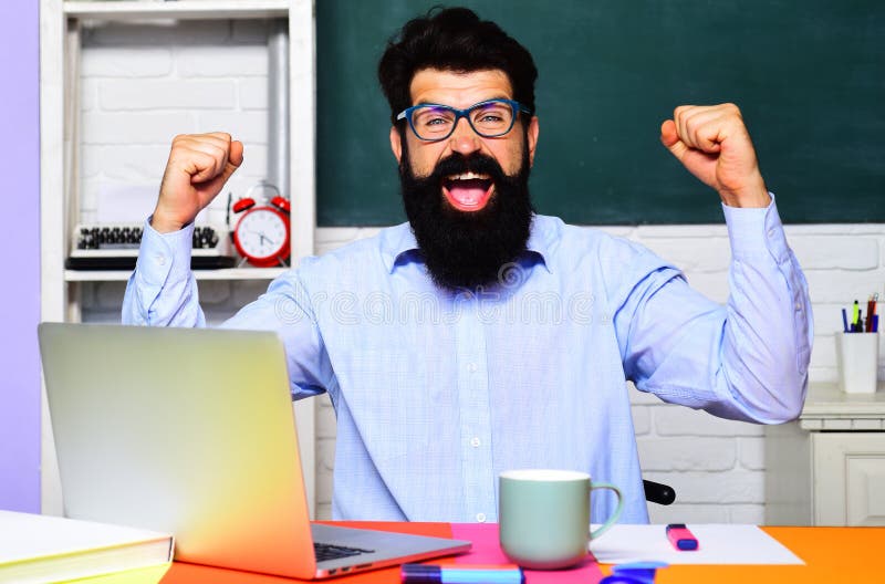 Happy male teacher in classroom. University student at college. World teachers day.