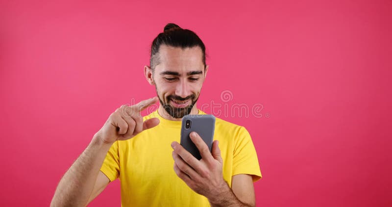 Happy man messaging using mobile phone