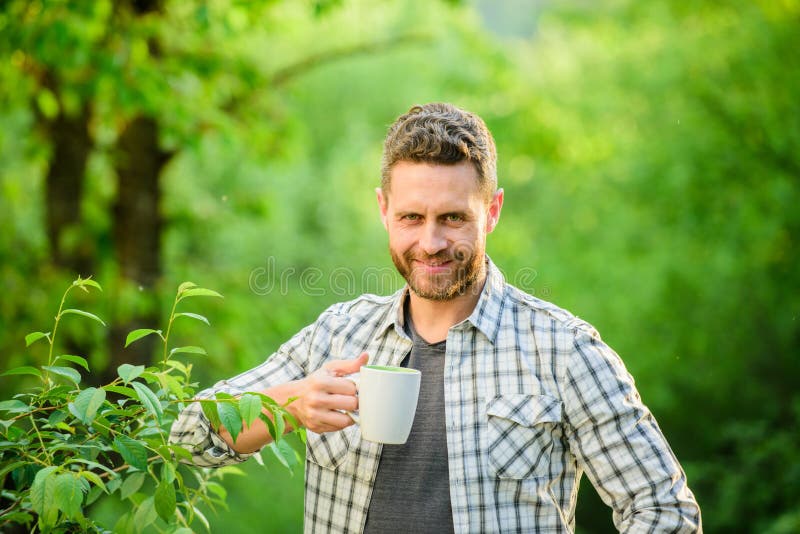Happy man with cup of tea. morning coffee. healthy lifestyle. nature and health. breakfast refreshment time. ecological. Life for man. man in green forest royalty free stock photography Happy man with cup of tea. morning coffee. healthy lifestyle. nature and health. breakfast refreshment time. ecological. Life for man. man in green forest royalty free stock photography