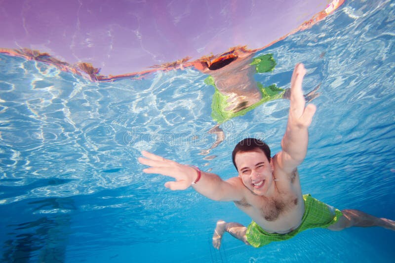 Happy man diving underwater stock images