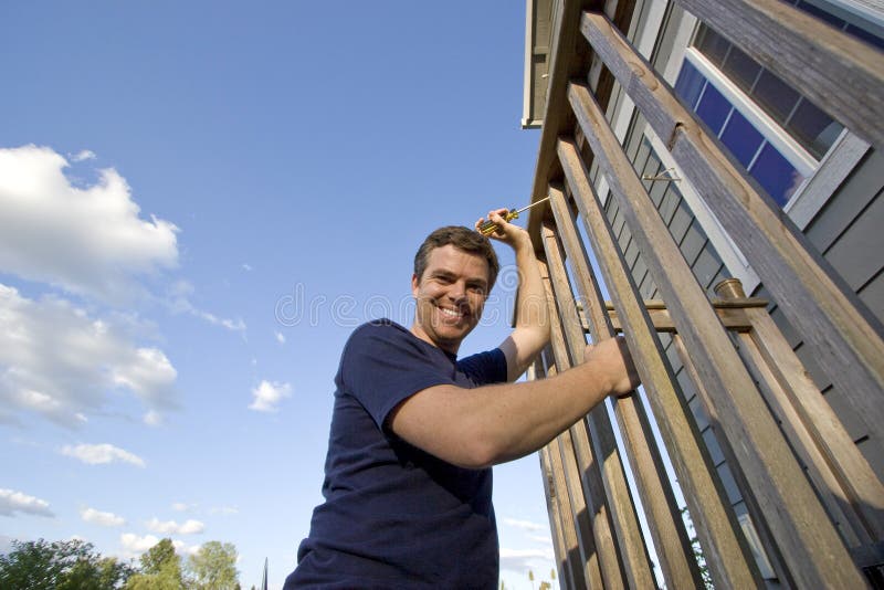 Happy Man Fixing House - Horizontal