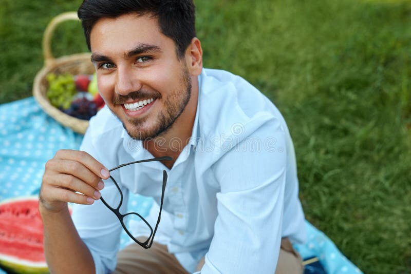 Happy Man. Handsome Smiling Young Male Outdoors In Park royalty free stock photography Happy Man. Handsome Smiling Young Male Outdoors In Park royalty free stock photography