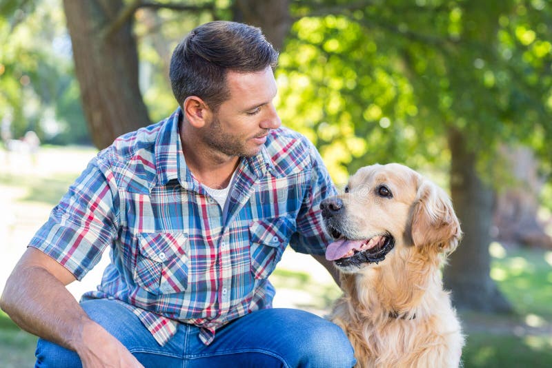 Happy man with his pet dog in park