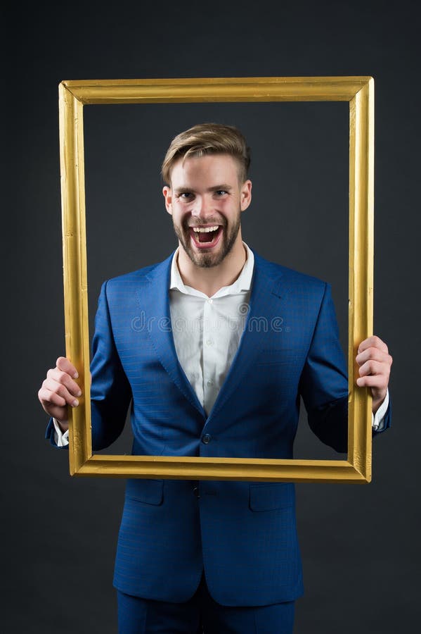 Happy man hold picture frame. Businessman smile through frame. Focus on me. Portrait of me. Family portrait. Catch the