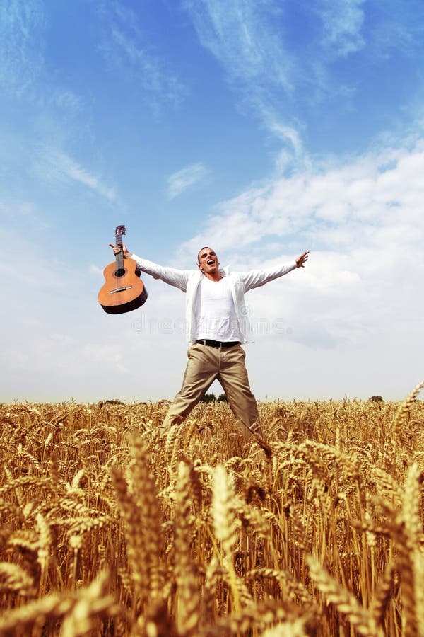 Happy man jumping in a wheat field stock photos Happy man jumping in a wheat field stock photos