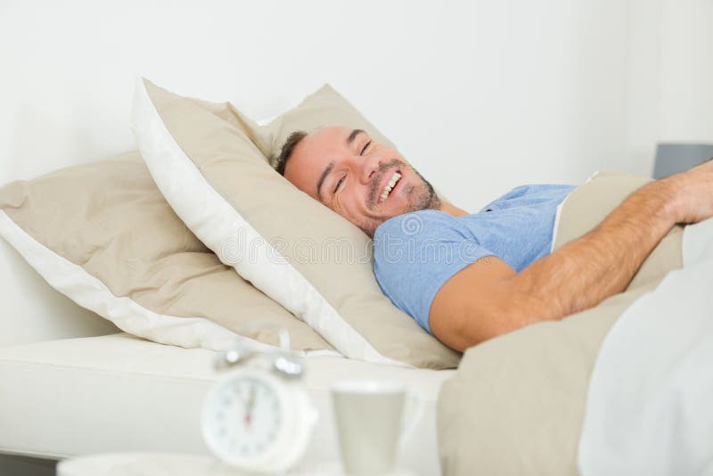 Happy man lay on bed stock photo. Image of linens, handsome 261511780
