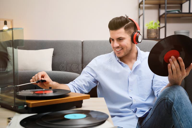 Happy man listening to music with turntable