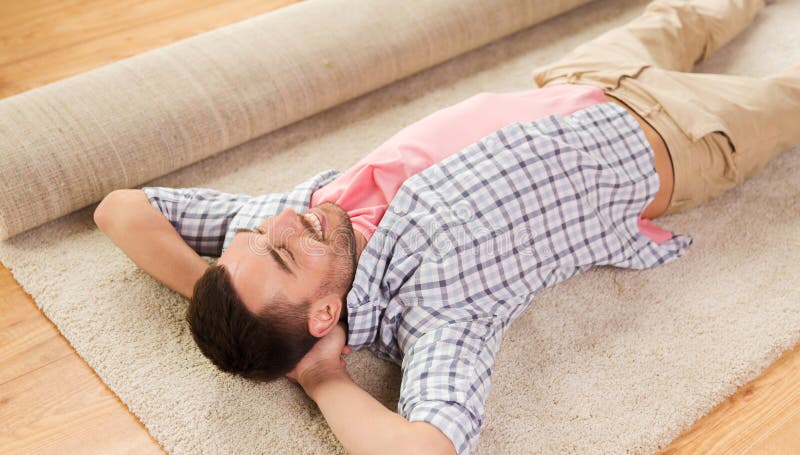 Happy man lying carpet or rug at home royalty free stock photo Happy man lying carpet or rug at home royalty free stock photo