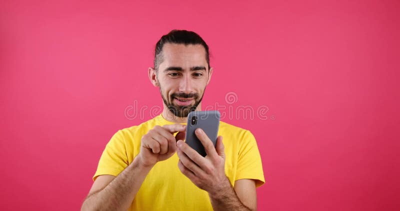 Happy man messaging using mobile phone