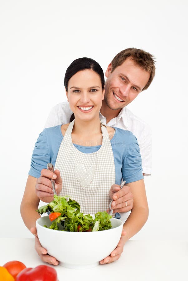 Happy man mixing a salad with his girlfriend royalty free stock images Happy man mixing a salad with his girlfriend royalty free stock images
