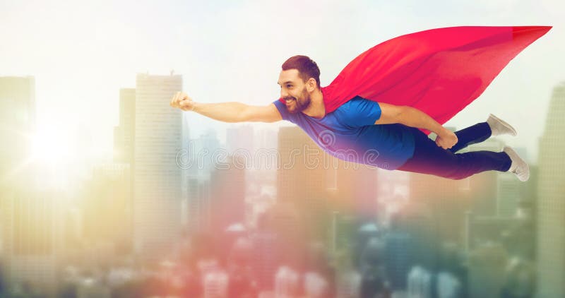 Happy man in red superhero cape flying on air