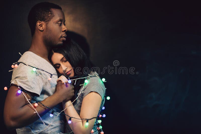 https://thumbs.dreamstime.com/b/happy-man-woman-couple-love-tenderness-interracial-relationship-bound-together-lights-holiday-ney-year-free-space-concept-93757617.jpg