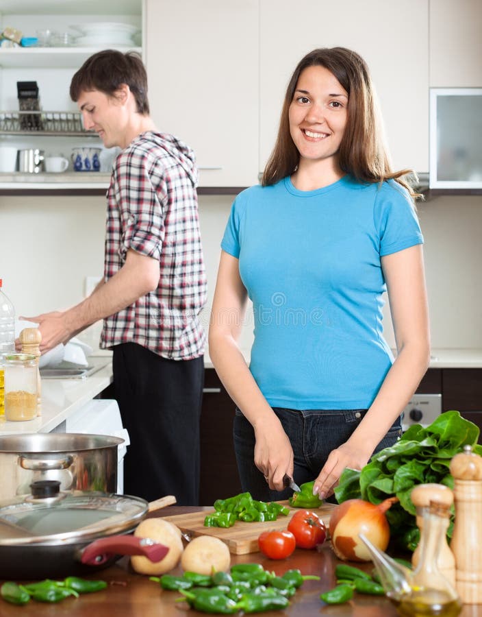 Happy man and the woman make dinner for himself royalty free stock image Happy man and the woman make dinner for himself royalty free stock image