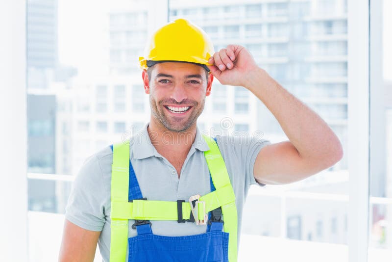 Happy manual worker wearing yellow hard hat stock images Happy manual worker wearing yellow hard hat stock images