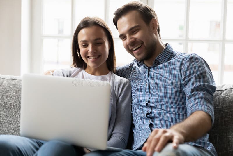 Happy Married Couple Watching Funny Video on Computer image