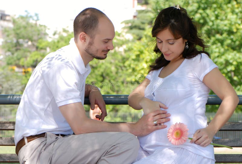 Happy married couple sitting on a bench