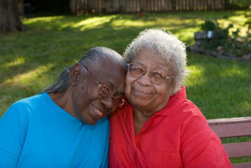 Happy mature African American sisters laughing and smiling. royalty free stock photography Happy mature African American sisters laughing and smiling. royalty free stock photography