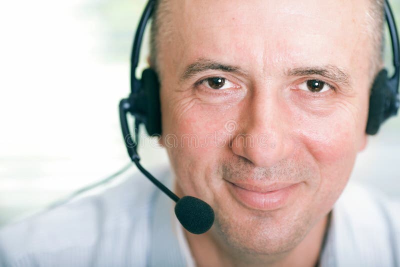 Closeup portrait of happy mature business man with headset