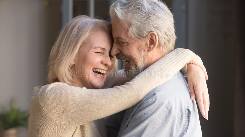 Happy mature couple embracing, laughing husband and wife, banner