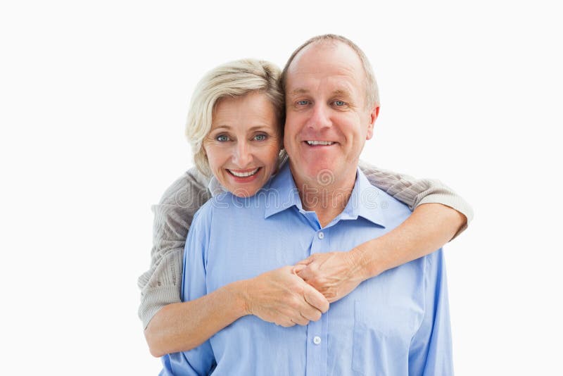Happy mature couple embracing smiling at camera on white background. Cut smiling stock images, royalty-free photos and pictures