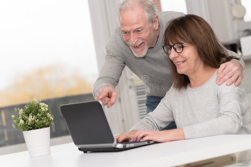 Happy Mature Couple Having A Good Surprise On Laptop Stock Image 
