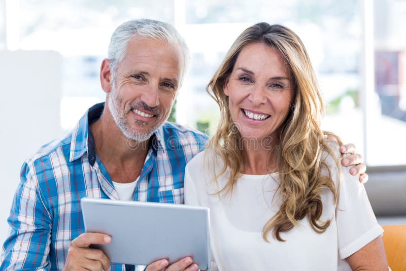 Mature Couple Using Digital Tablet Outdoors