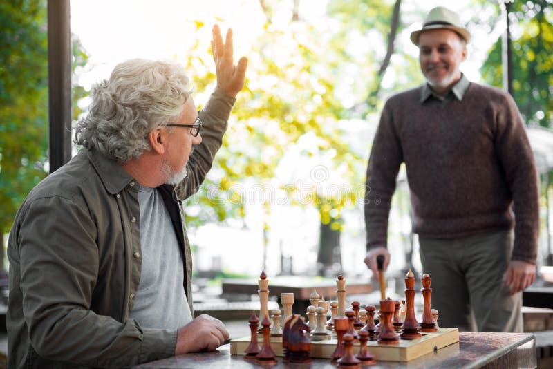 Happy mature man meeting friend in park