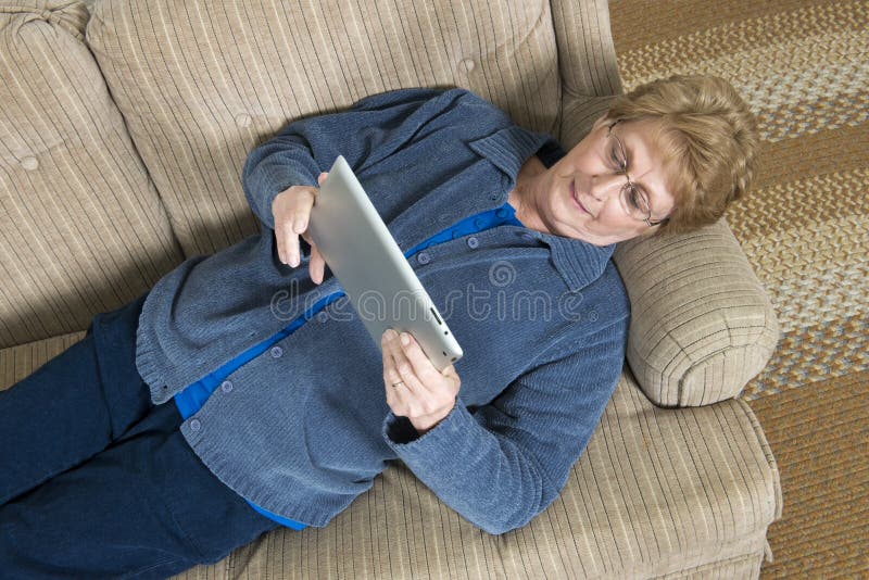 Mature Senior Elderly Woman Use Ipad Computer royalty free stock photos Mature Senior Elderly Woman Use Ipad Computer royalty free stock photos