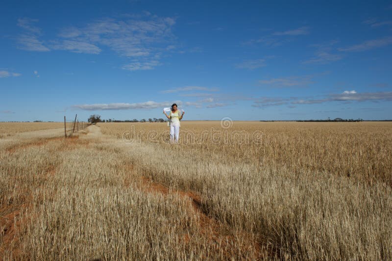 Happy Mature Woman in Field of Wheat