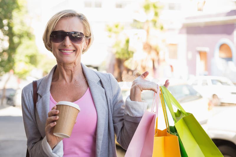 Happy Mature Woman Walking with Her Shopping Purchases Stock Photo ...