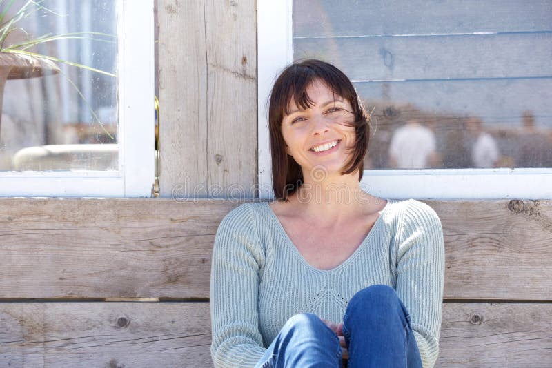 Happy middle aged woman smiling outdoors