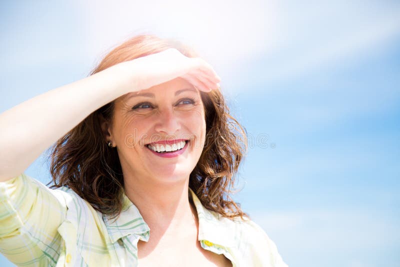 Happy midle aged woman protecting from sun