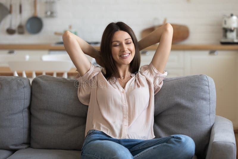 Happy Millennial Girl Relax on Comfortable Sofa at Home Stock Photo ...