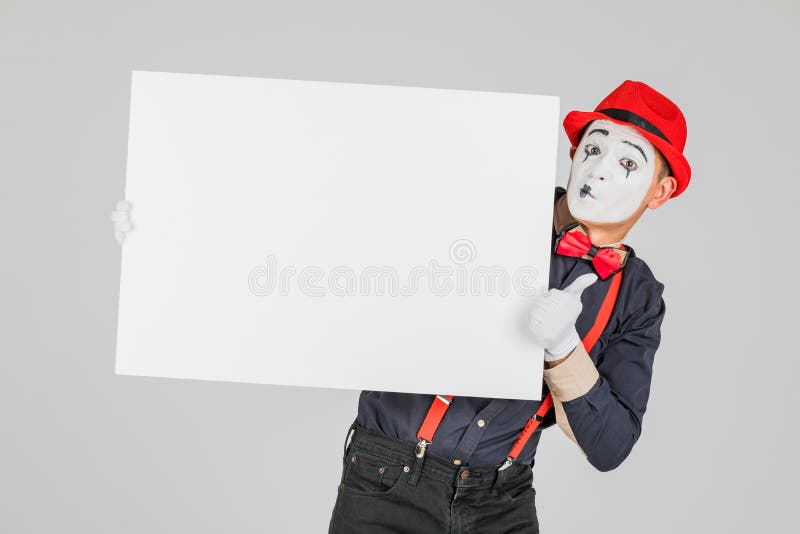 happy MIME artist holding a blank white Board, on a white background. stock photography happy MIME artist holding a blank white Board, on a white background. stock photography