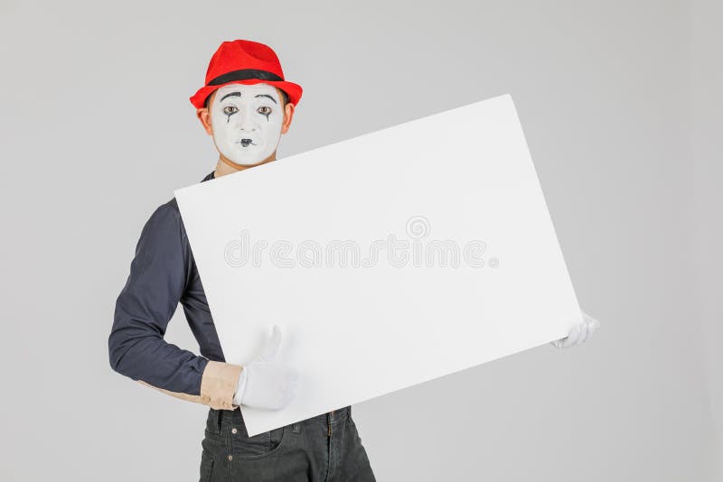 happy MIME artist holding a blank white Board, on a white background. royalty free stock images happy MIME artist holding a blank white Board, on a white background. royalty free stock images