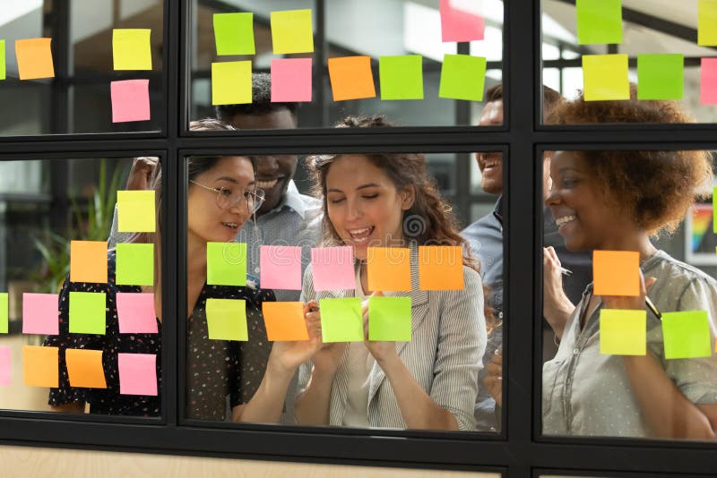 Diverse teammates satisfied with working process at office. royalty free stock photography Diverse teammates satisfied with working process at office. royalty free stock photography