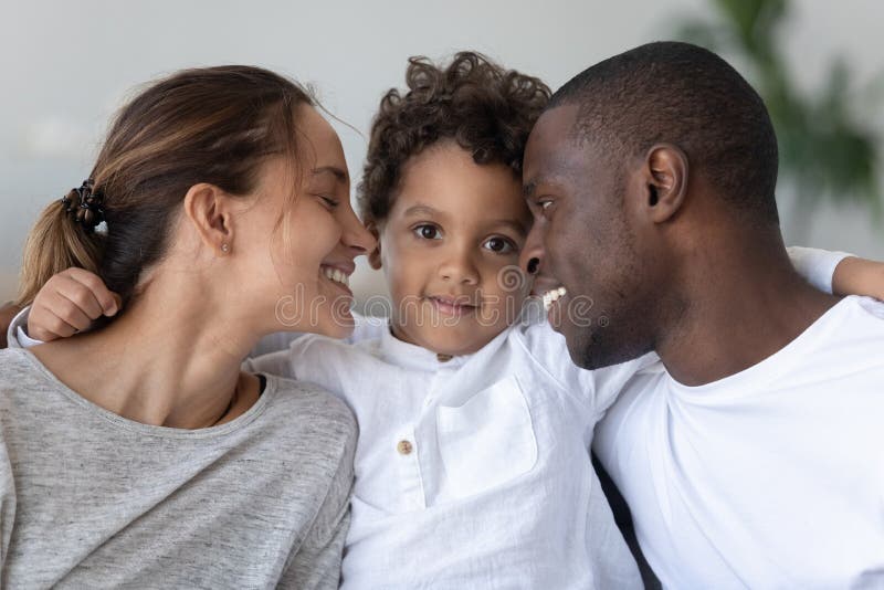 Happy mixed race family bonding head shot close up portrait.