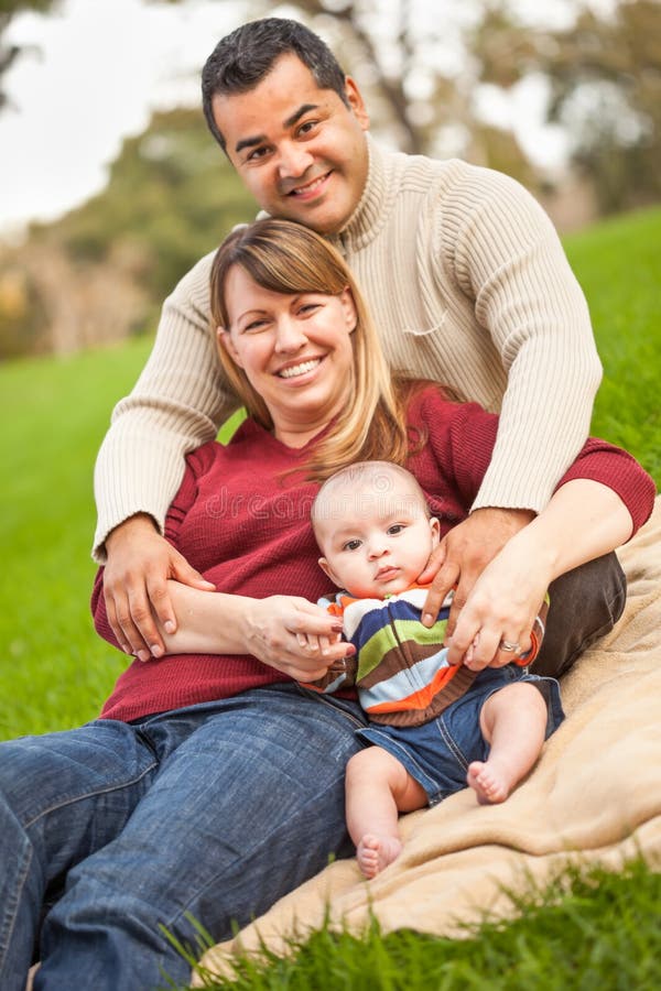 Happy Mixed Race Family Posing for A Portrait in the Park stock images Happy Mixed Race Family Posing for A Portrait in the Park stock images