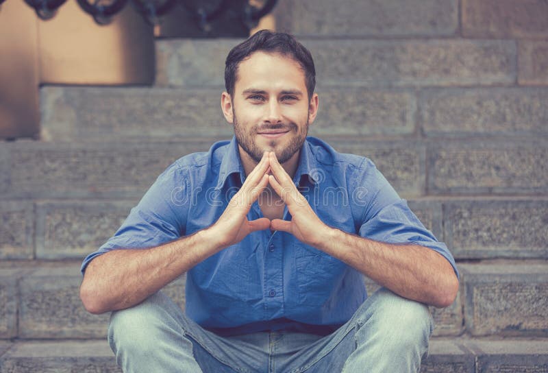 Happy modern young man smiling sitting outdoors royalty free stock image Happy modern young man smiling sitting outdoors royalty free stock image